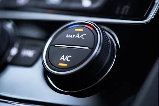 Close-up view of a car's A/C control dial set to Max A/C, representing automotive air conditioning functionality and cabin climate control.