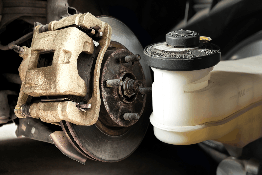 Brake caliper replacement and fluid flush, auto repair in South Jordan, UT, at Performance Place. Image of a brake caliper, rotor, and brake fluid reservoir during brake service, highlighting expert maintenance that improves braking performance, safety, and long-term reliability.
